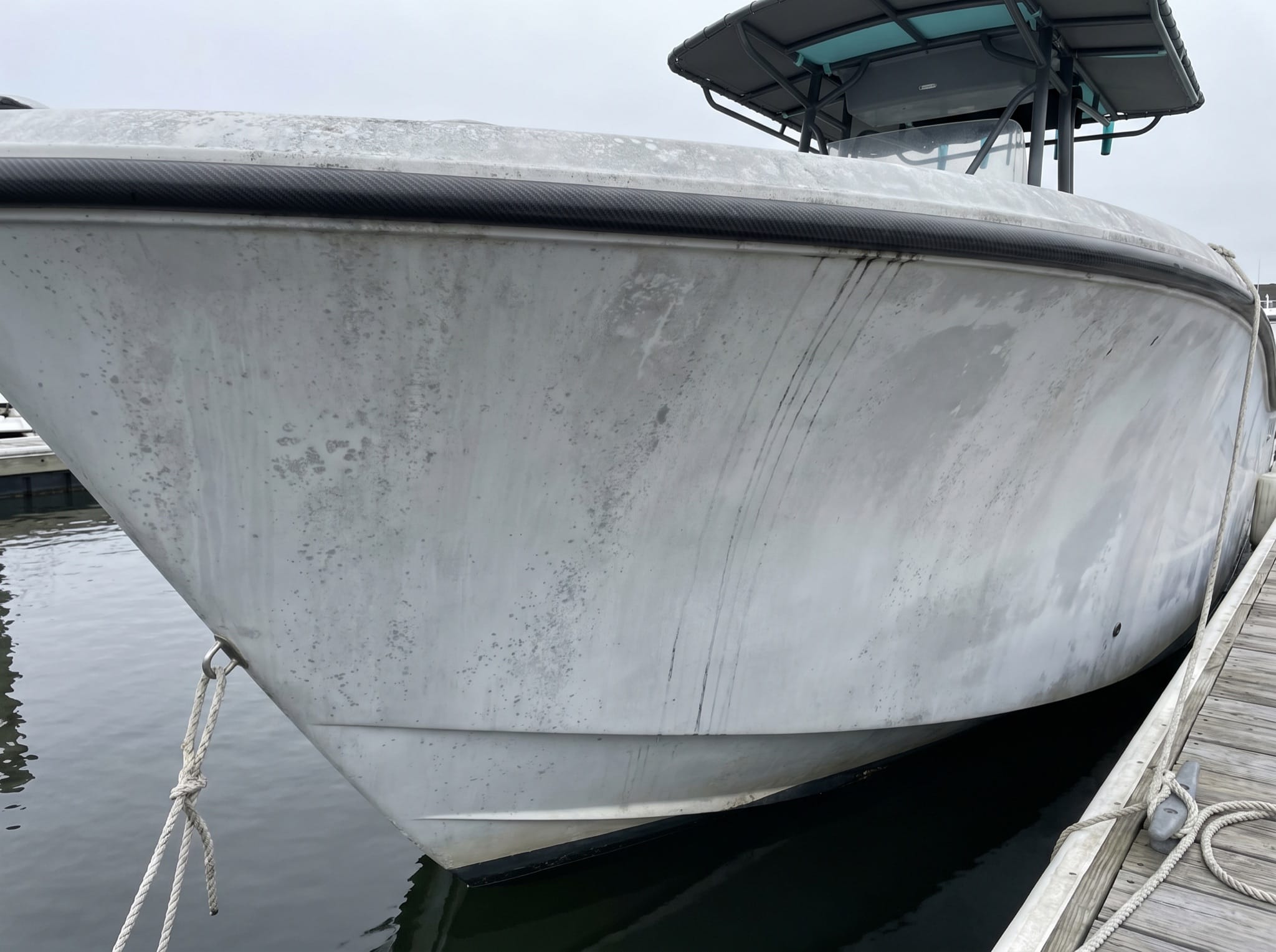 Dull, oxidized gelcoat with grime streaks before coating